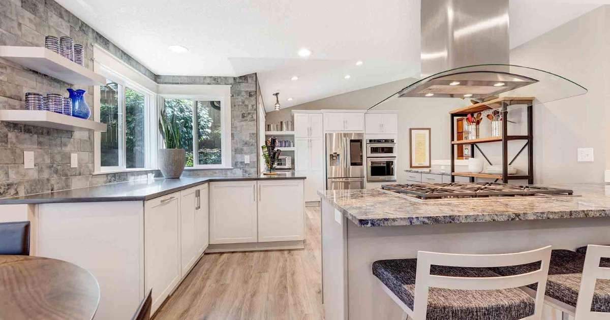 Image of a kitchen remodel with stovetop island, natural light, custom cabinets in Portland, OR by Creekstone