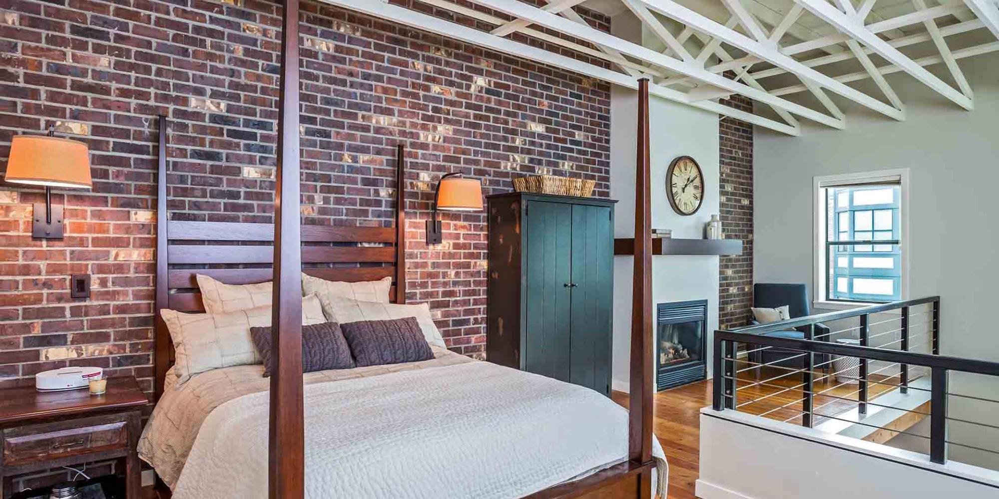 Image of a remodeled loft with brick features, railing, and fireplace by Creekstone Design and Remodel in Portland, OR