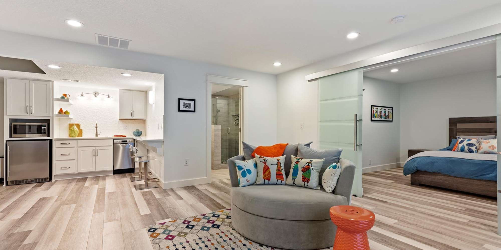 Finished basement remodel in Portland, OR featuring open living space, bedroom suite, and custom kitchenette