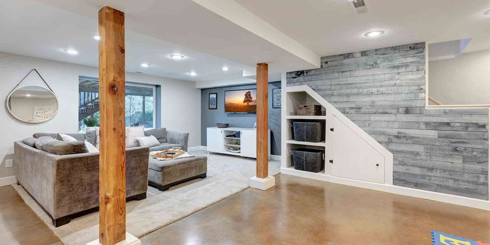 Modern basement living room remodel in Portland, OR featuring built-in storage and rustic wood accents
