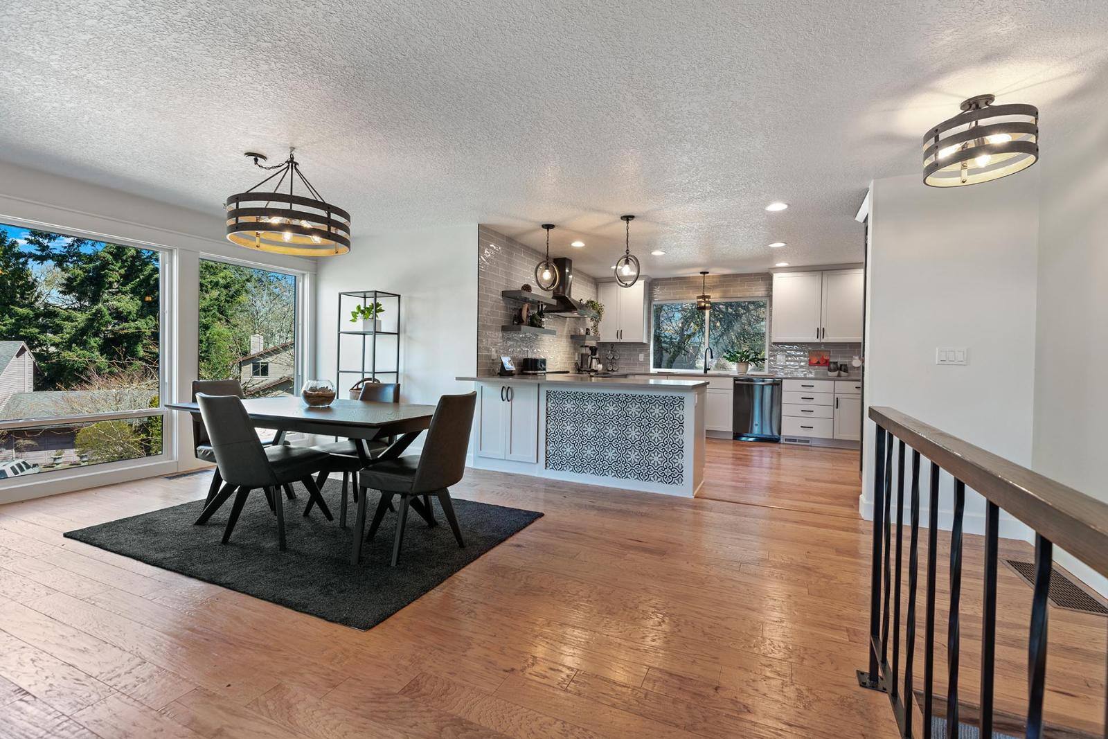 Remodeled open plan kitchen and dining area by Creekstone Design + Remodel
