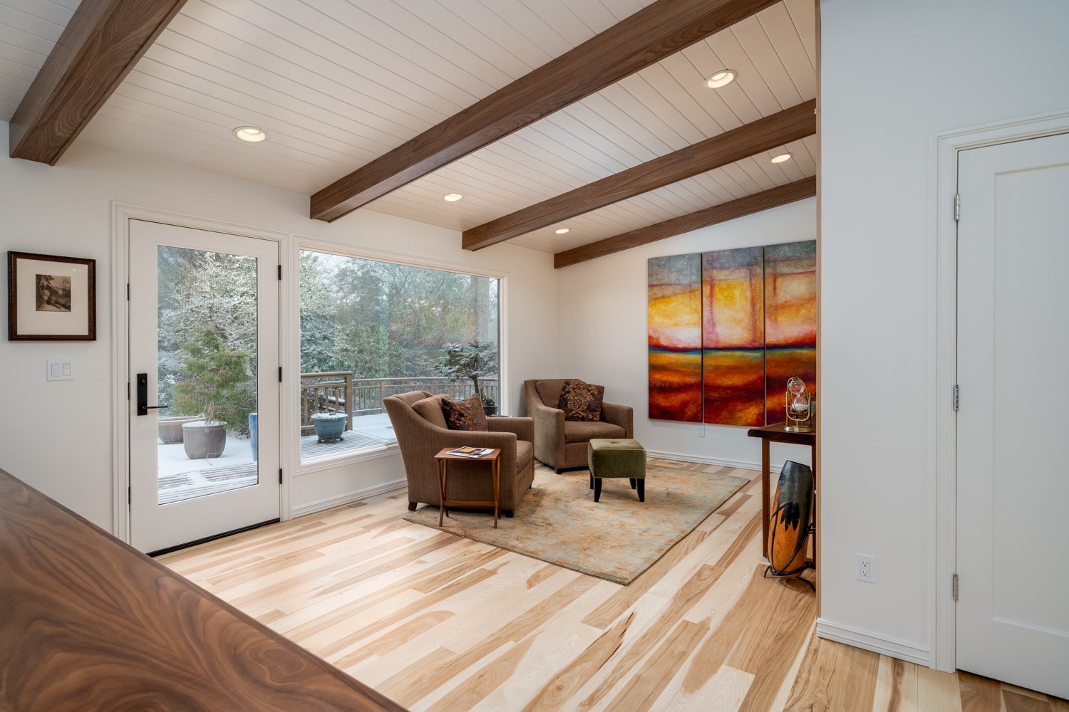 Modern den showcasing wood textures, bright lighting, and a cozy seating arrangement, designed for a whole home remodel in Portland, OR by Creekstone Design + Remodel Modern den showcasing wood textures, bright lighting, and a cozy seating arrangement, designed for a whole home remodel in Portland, OR by Creekstone Design + Remodel