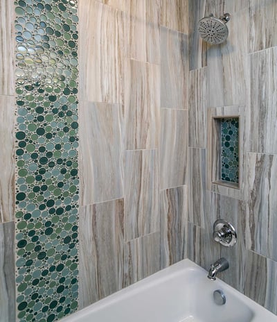 Bathroom tub and shower combination full tile walls featuring accent bubble tile strips in custom remodeled bathroom by Creekstone Design + Remodel