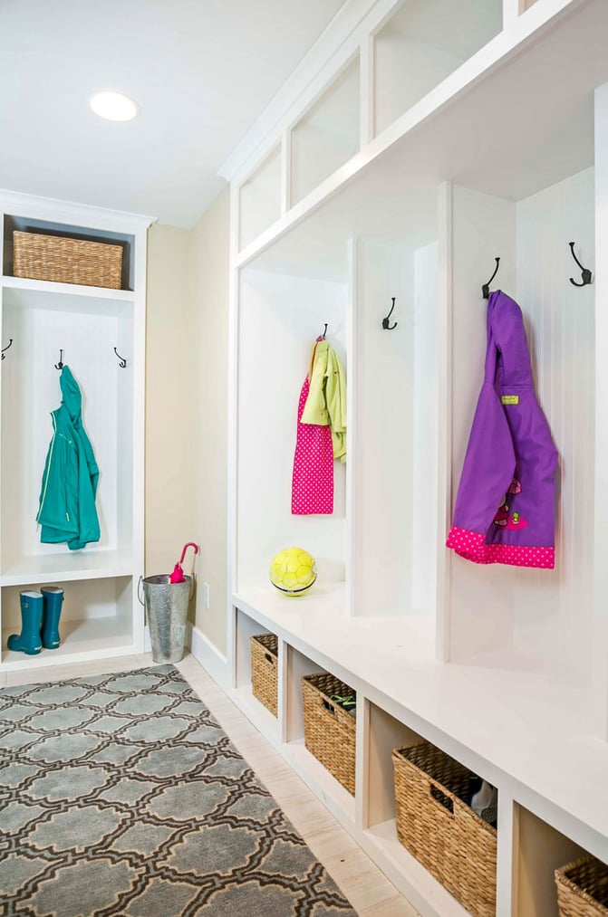 Tile-Floor-Mudroom-with-framed-Cubbies-and-Cabinets-for-Coats-Boots-and-Island-Rug-1