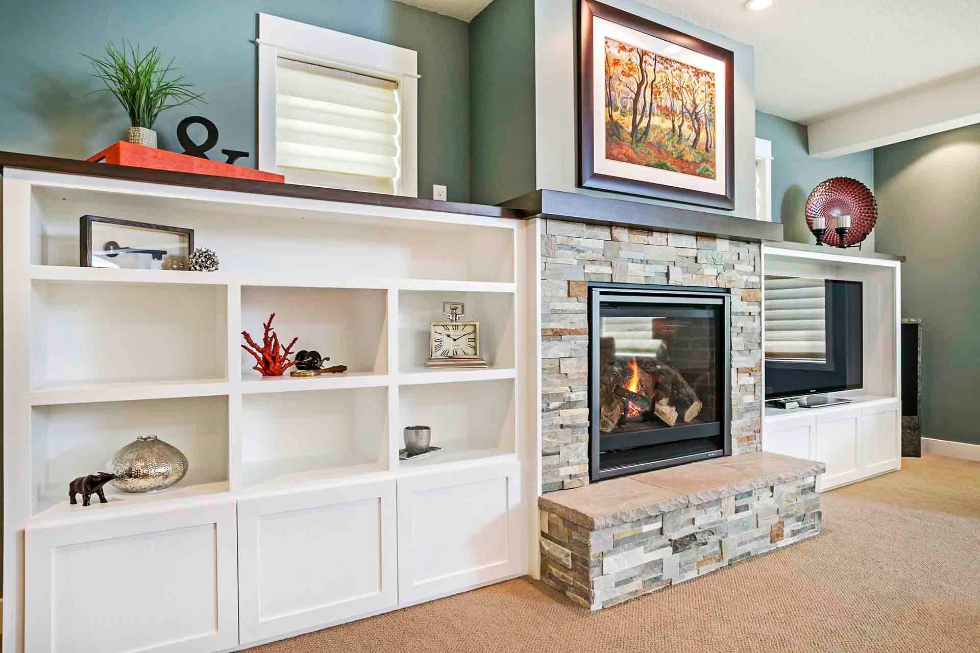 Entertainment area featuring a stone fireplace and built-in shelves in Portland, OR