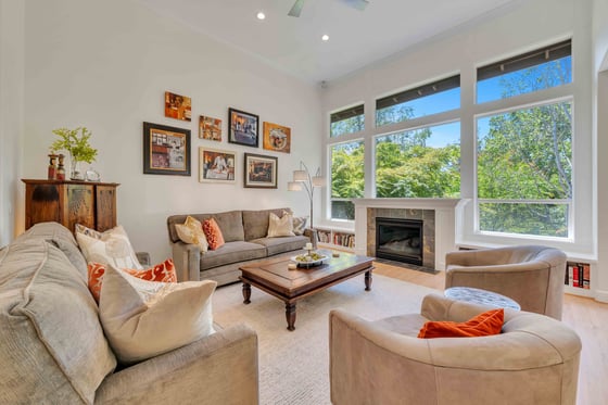 Remodeled living room featuring built-in shelving and natural light by Creekstone Design + Remodel in Portland, OR