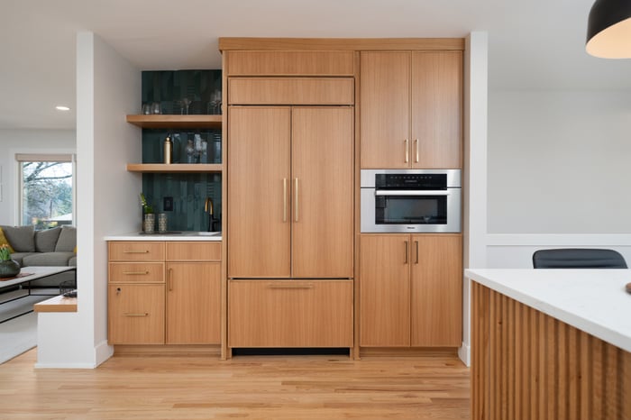 Built-in fridge and undercounter bar sink featured in a Hillsdale remodel by Creekstone Design + Remodel