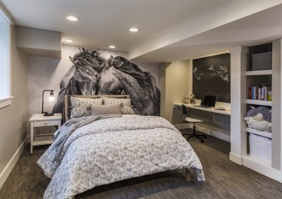 Basement-bedroom-with-full-wall-accent-picture-mural-built-in-shelving-and-study-nook-400x283