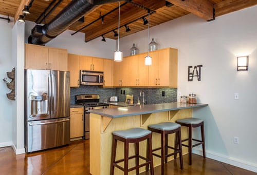 Industrial-Kitchen-Concrete-Floors-Exposed-Wood-Beams