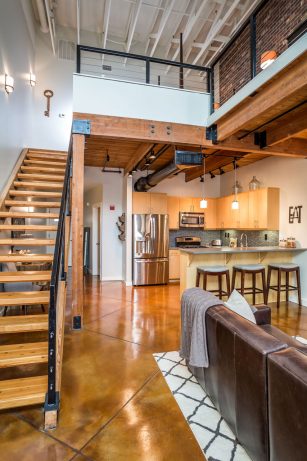 Industrial-Kitchen-with-Built-in-Cabinets-Concreet-Floors-Exposed-Wood-Beams-Pendant-Lights-Black-Track-Lights-Grey-Countertops-Island-Seating-Mosaic--3