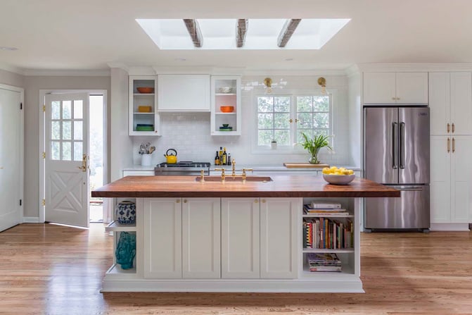Large-Kitchen-Island-with-Walnut-Countertop-and-Open-Shelving-Oversized-Skylight-With-Rustic-Beams