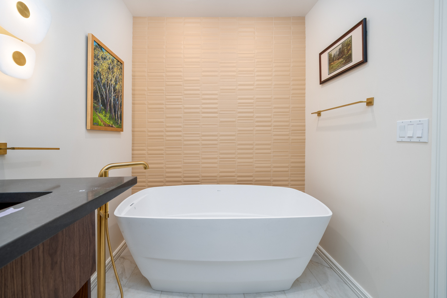 Bright and elegant bathroom design with a spa-like aesthetic, featuring a freestanding bathtub and gold accents, part of a whole home remodel in Portland, OR by Creekstone Design + Remodel