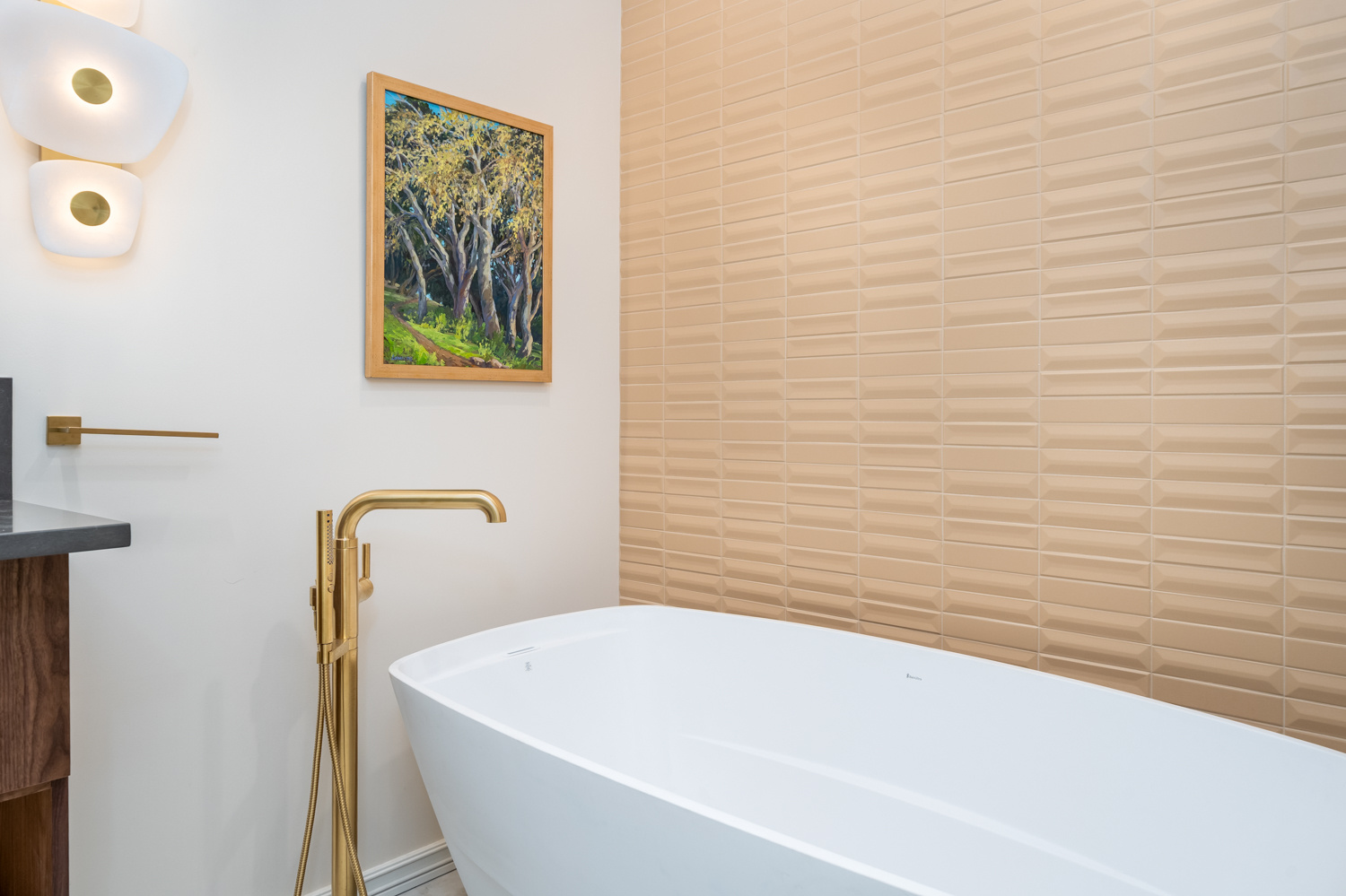 Modern bathroom design featuring a dark stone vanity, gold faucet, and stylish lighting, included in a whole home remodel in Portland, OR by Creekstone Design + Remodel