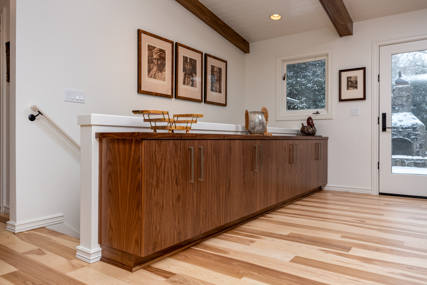 Modern built-in storage unit with mid-century inspired wood textures and minimalistic hardware, part of a whole home remodel in Portland, OR by Creekstone Design + Remodel