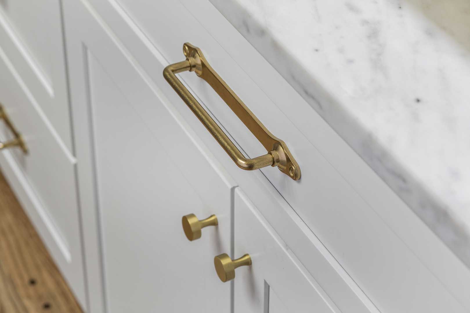 Close up of brushed brass cabinet pulls