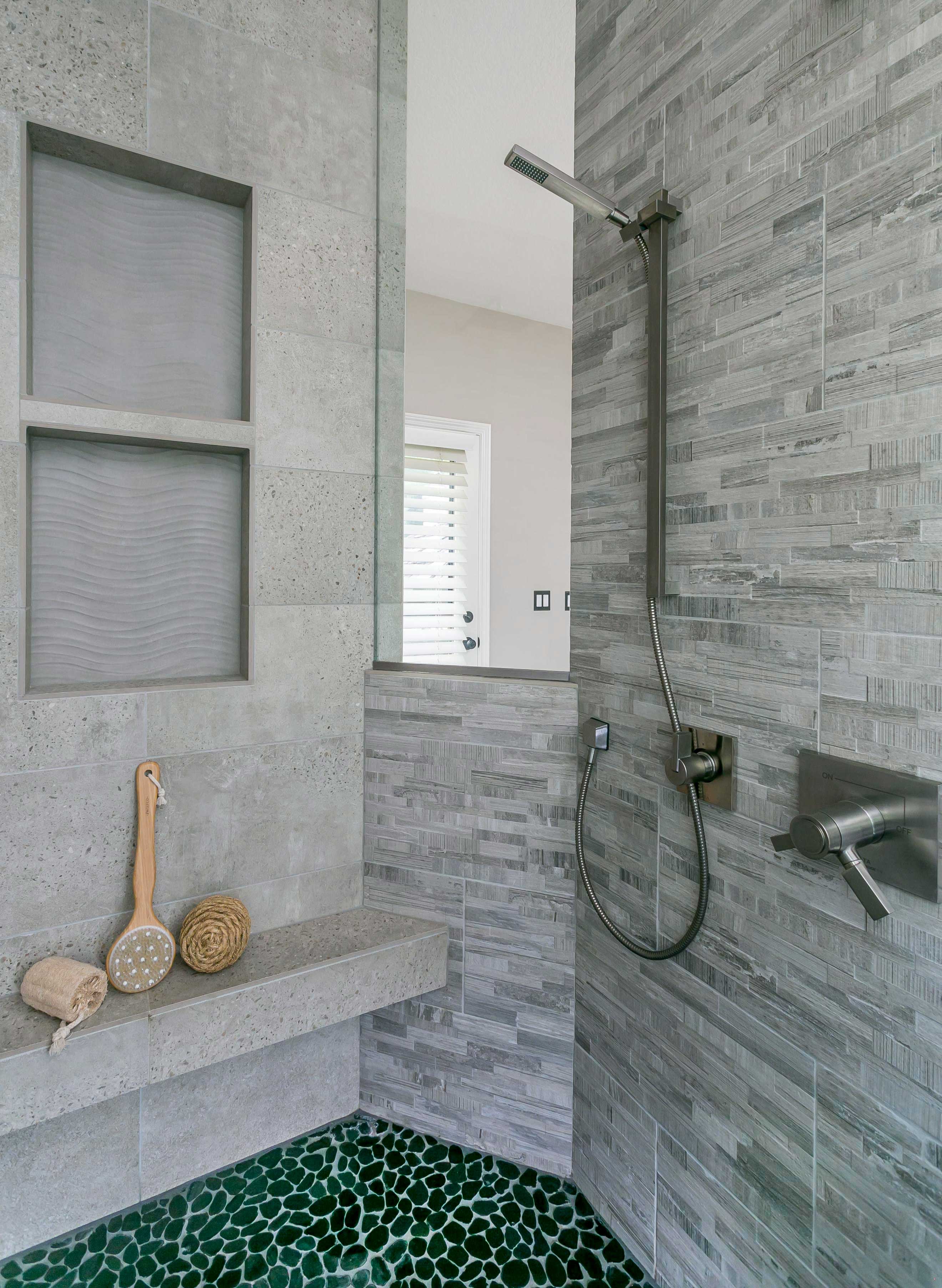 Master walk in shower remodel with window, grey tile, and green pebble shower floor