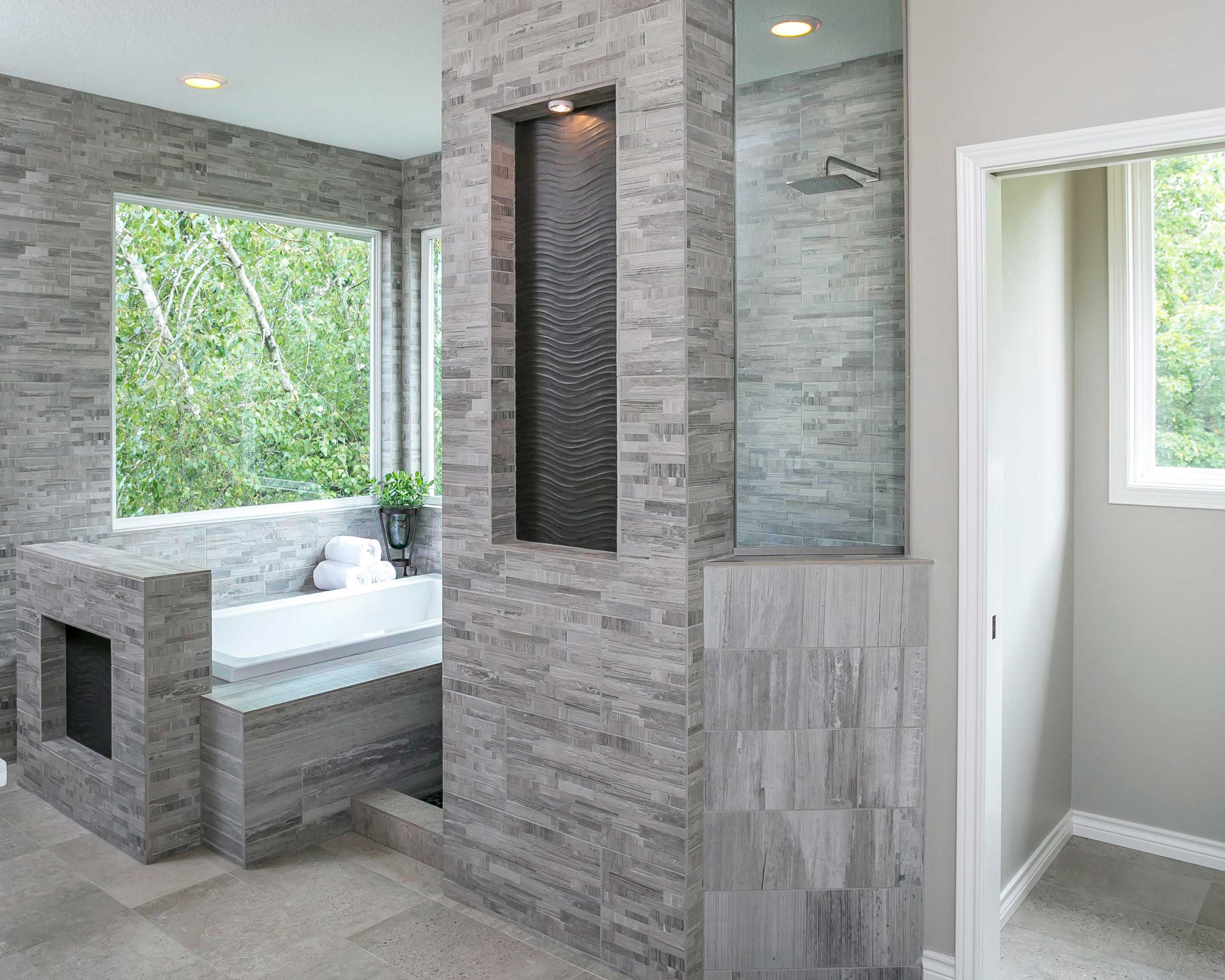 Master bathroom remodel with grey tiled tub and walk in shower