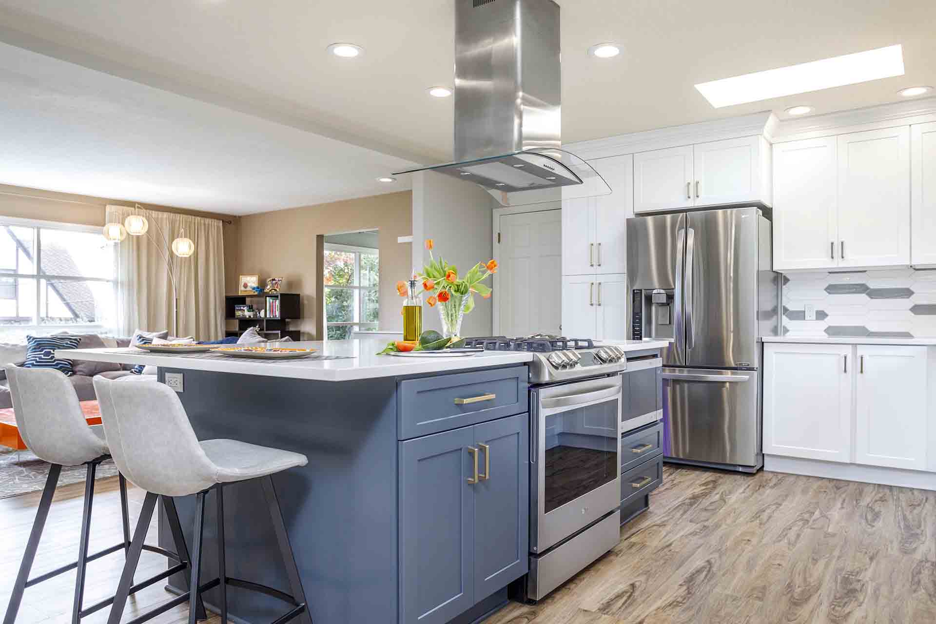 other view of kitchen island and fridge