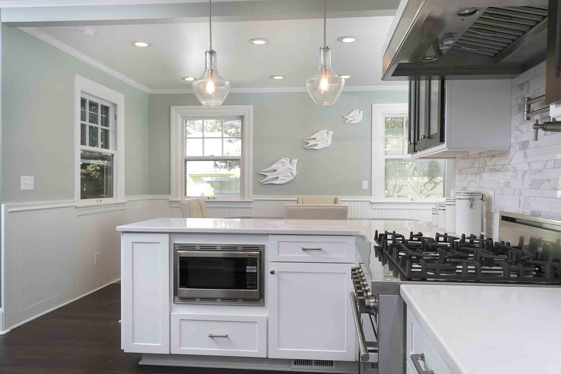 Kitchen with stove on the right and drawer microwave