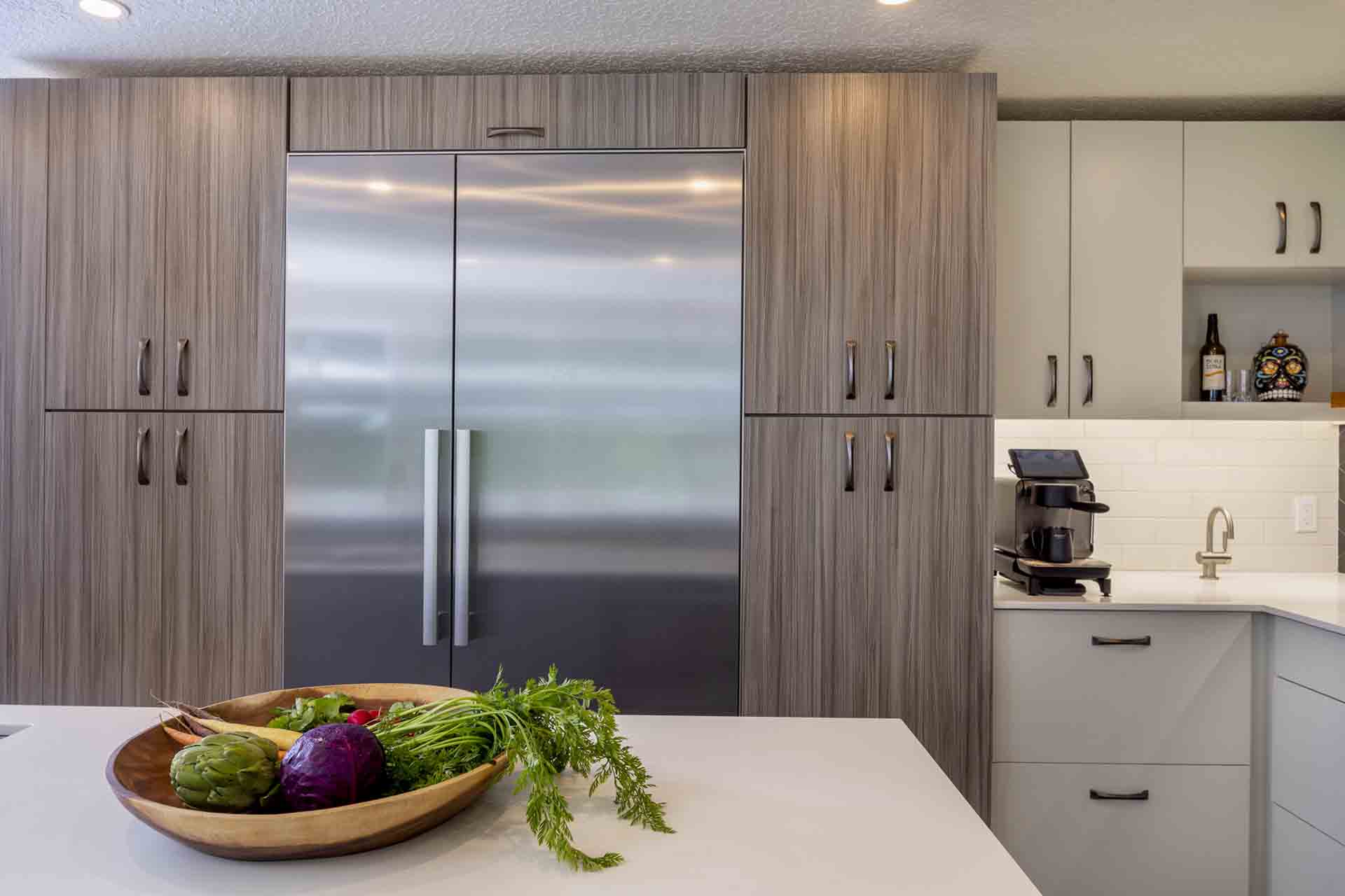 fridge with kitchen island in the foreground