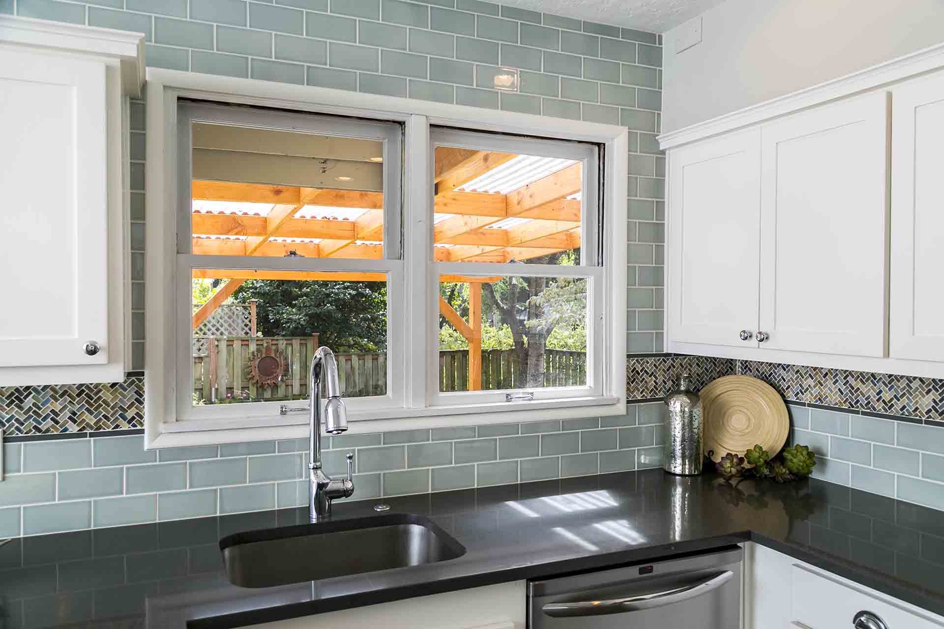 View of kitchen sink with big window