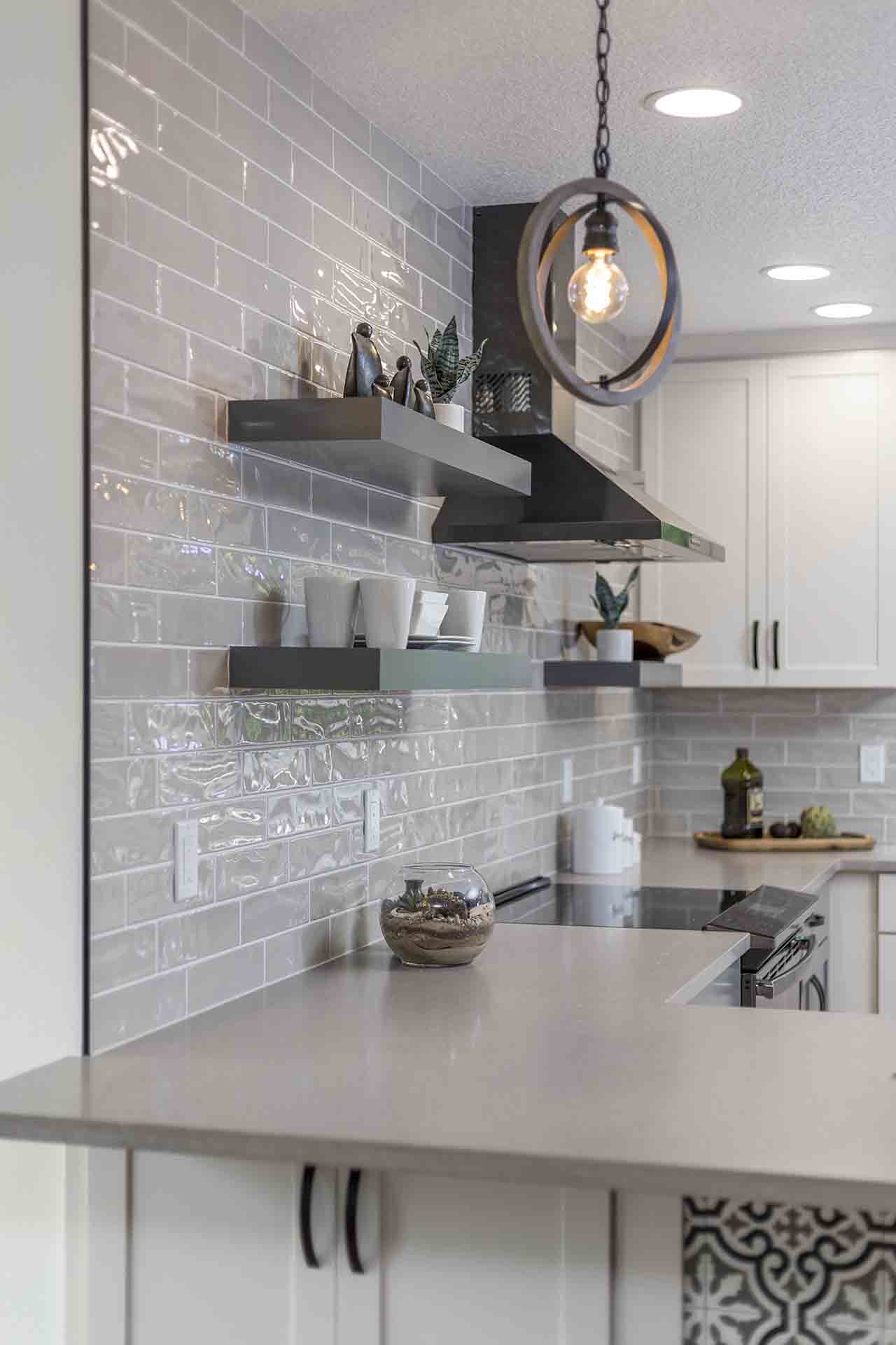 Corner of the counter with stove and floating shelves in the background