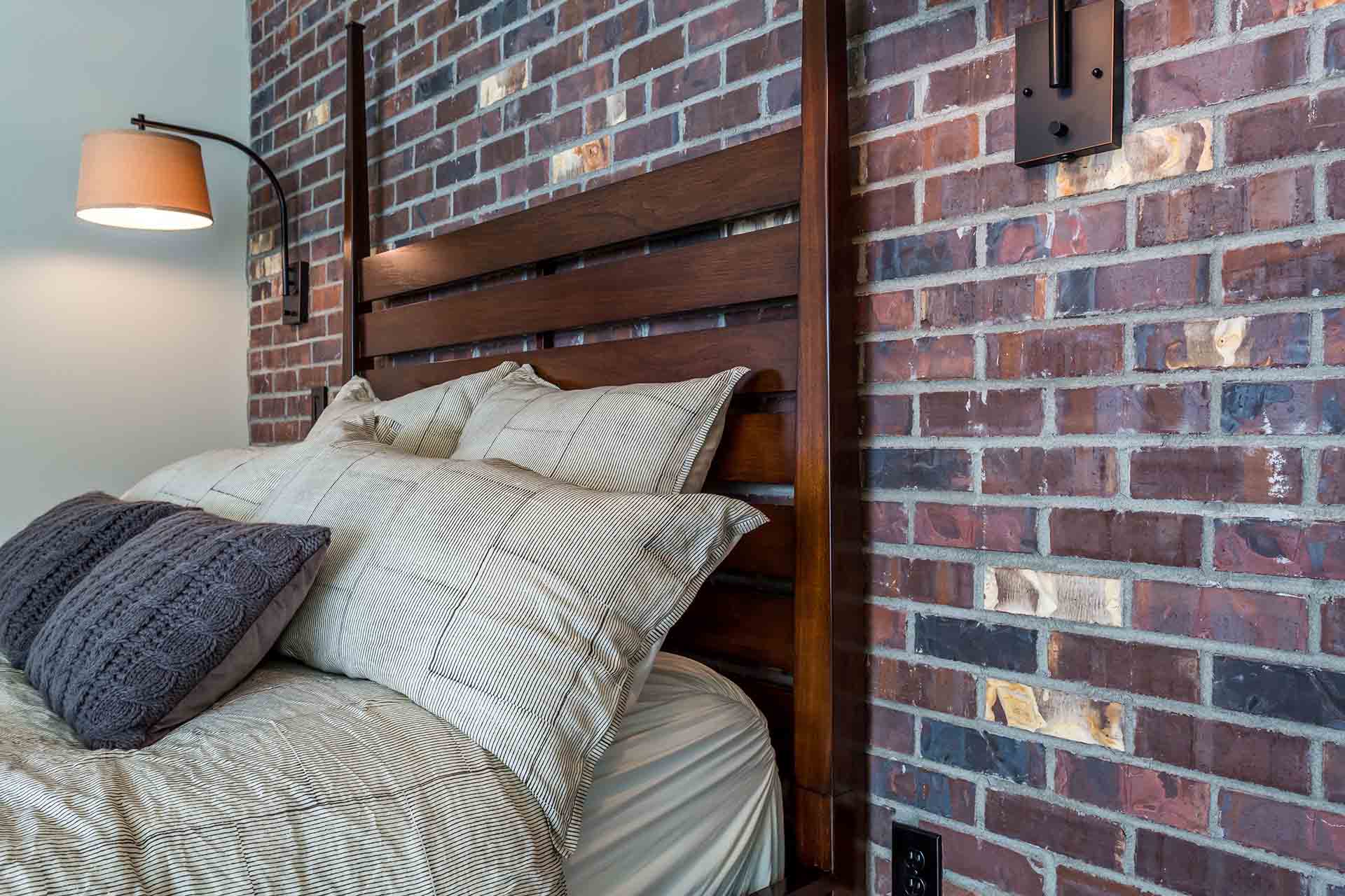 bed against exposed brick wall